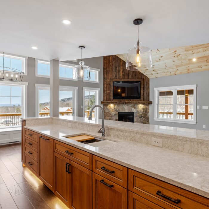 A cozy and warm living area featuring an open kitchen and living room, with a fireplace