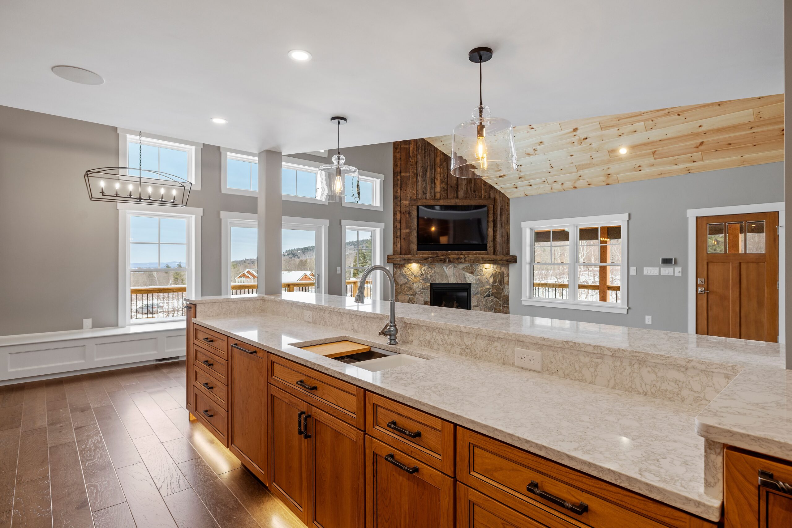 A cozy and warm living area featuring an open kitchen and living room, with a fireplace