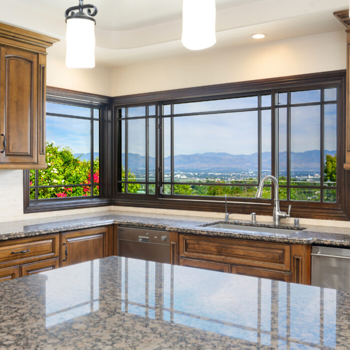 A kitchen island with granite countertops and counters in modern kitchen in Encino, California