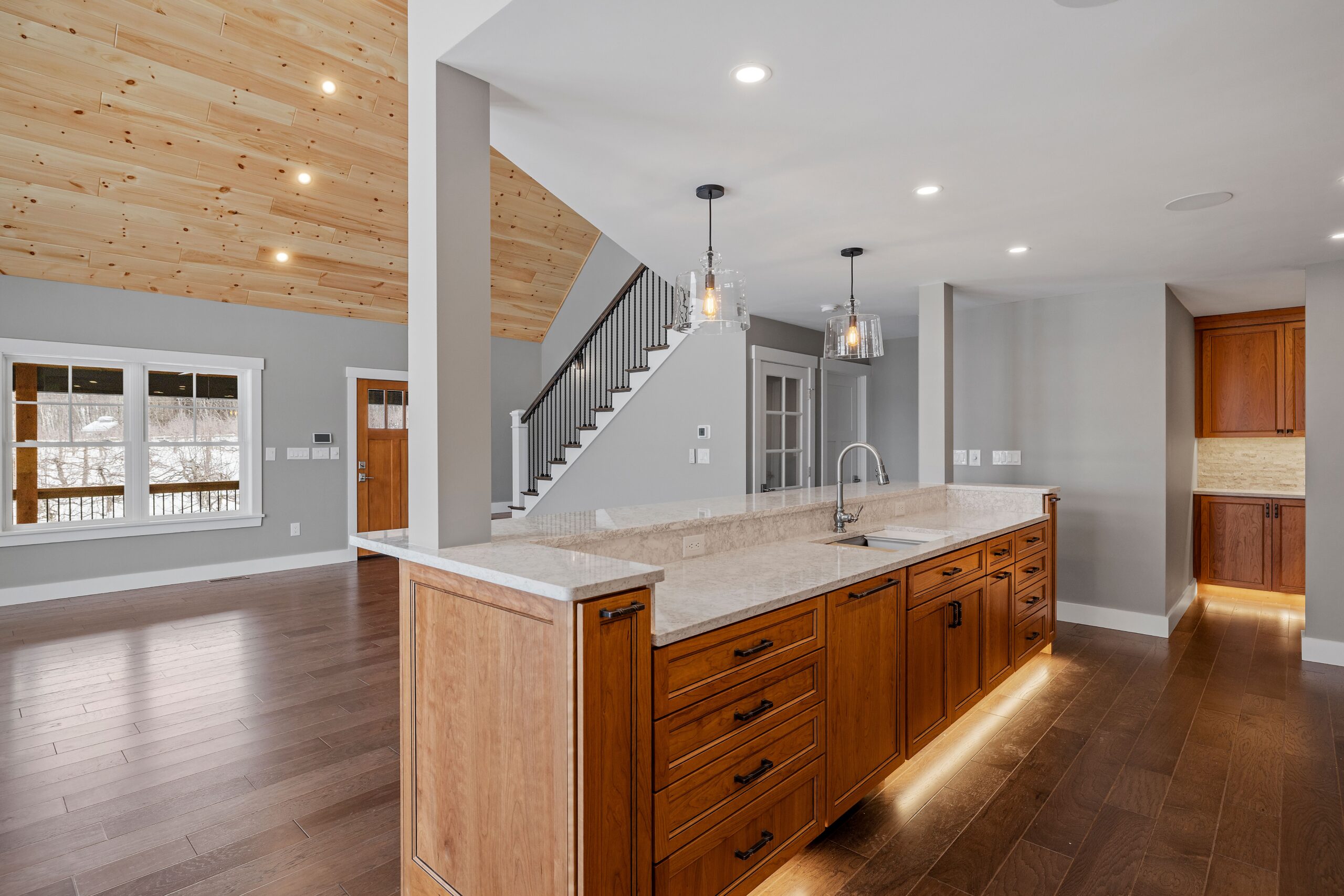 A modern kitchen featuring hardwood floors and stylish furniture